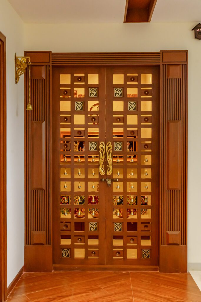 Teak wood pooja door with traditional carvings.