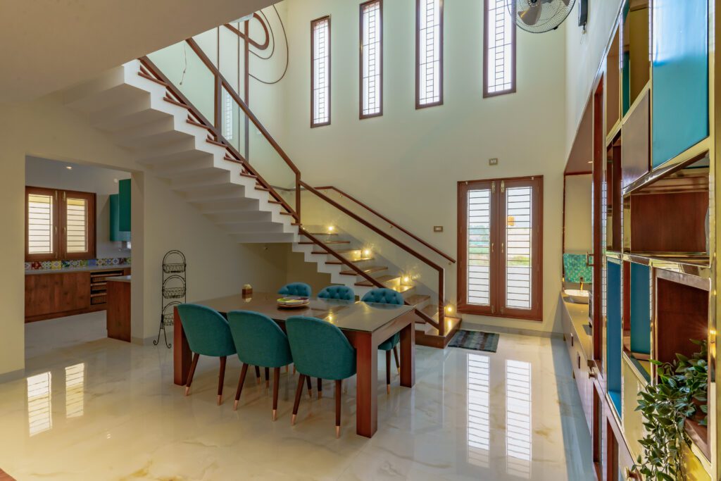 Double-height dining room illuminated by skylights.