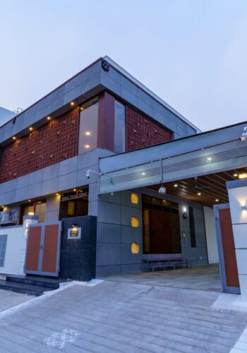 Modern facade of a 3BHK house in Salem featuring exposed concrete panels.